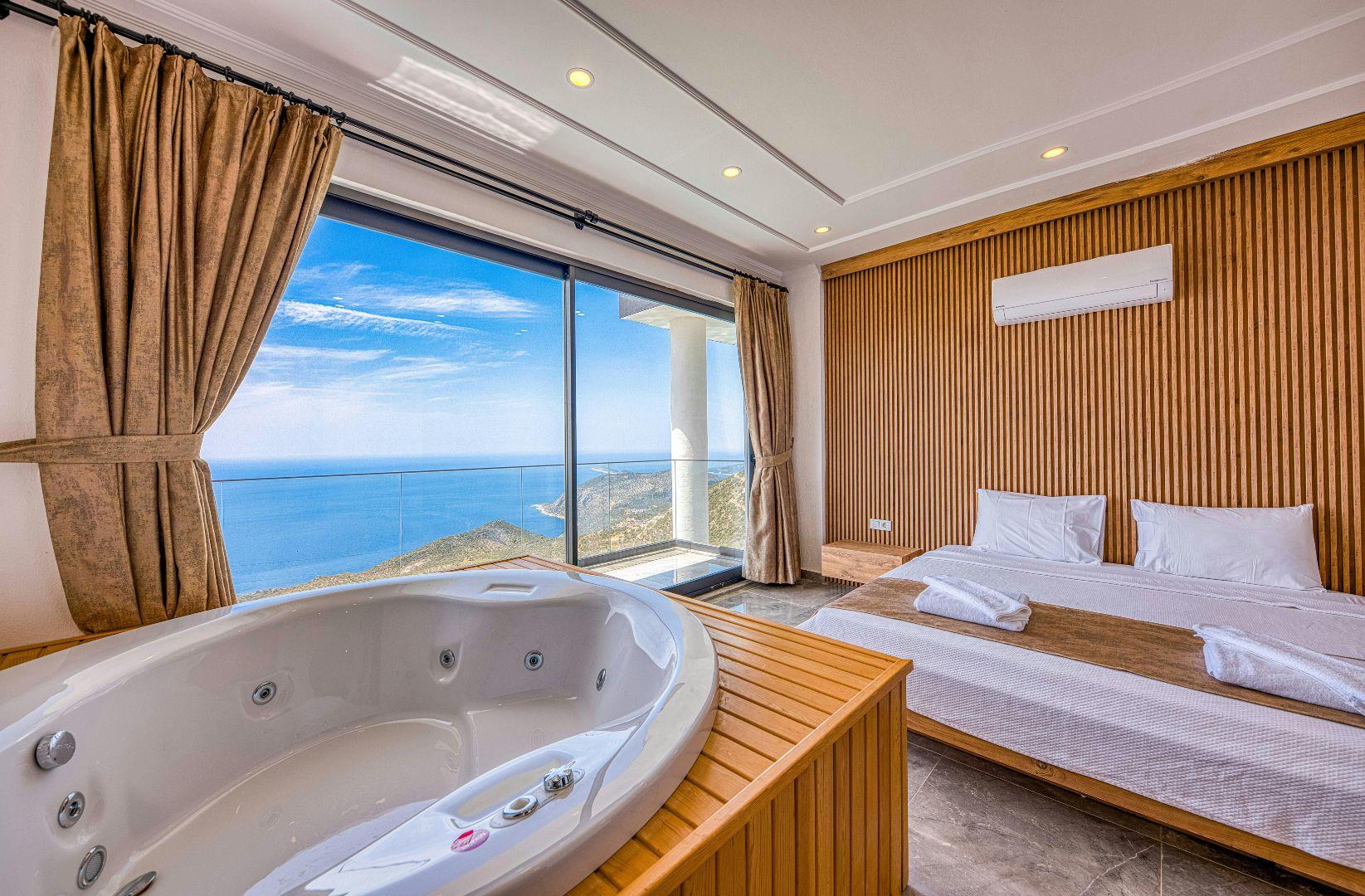 Habitación con jacuzzi y ventanal con vista al mar
